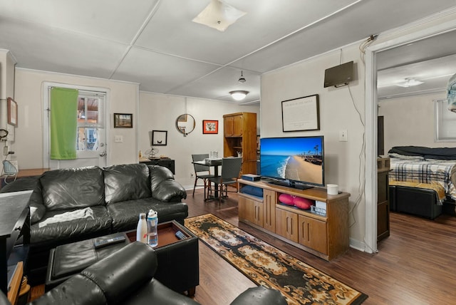 living area featuring baseboards and wood finished floors