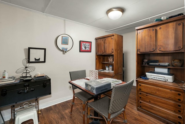 kitchen with brown cabinetry, dark wood-style flooring, and baseboards