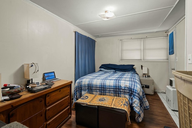 bedroom with dark wood-style flooring