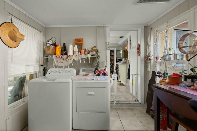 washroom featuring visible vents, separate washer and dryer, crown molding, and light tile patterned flooring