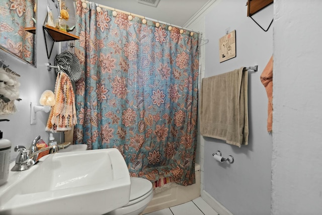 bathroom with tile patterned flooring, toilet, shower / tub combo, a sink, and visible vents