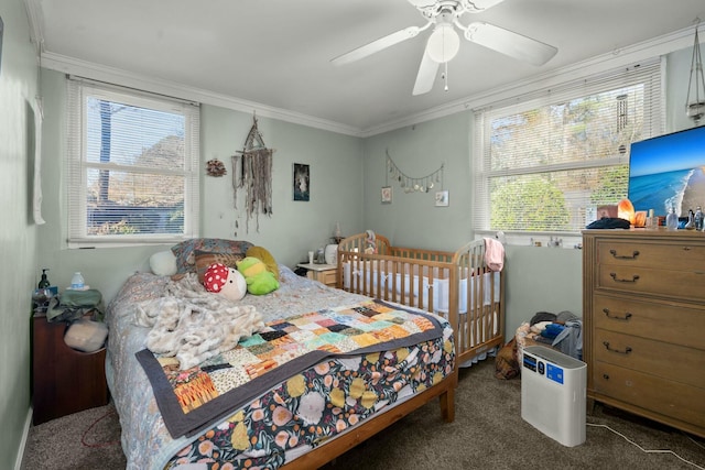 carpeted bedroom featuring a ceiling fan and crown molding