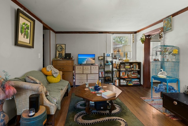 living room featuring ornamental molding and wood finished floors