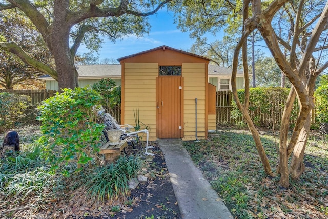 view of shed featuring fence