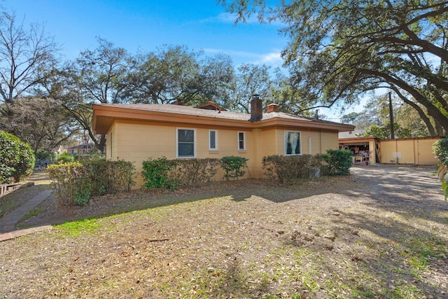 rear view of property featuring a chimney