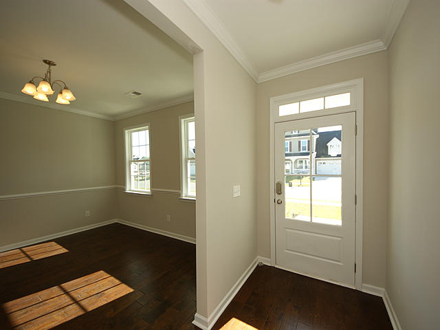 foyer entrance with dark hardwood / wood-style floors, a healthy amount of sunlight, and an inviting chandelier