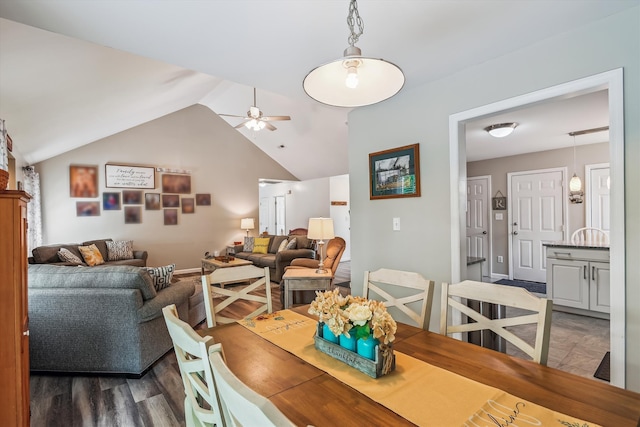 dining area with wood finished floors, a ceiling fan, and lofted ceiling