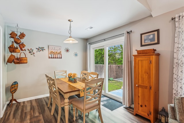 dining area featuring baseboards, visible vents, and wood finished floors