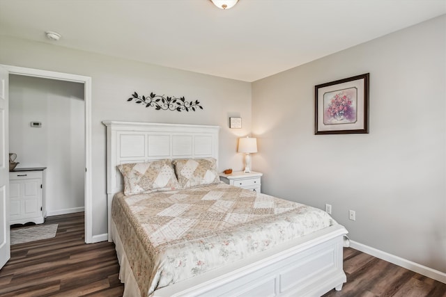 bedroom with baseboards and dark wood finished floors