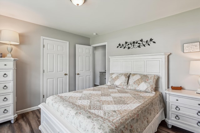bedroom with baseboards and dark wood-style floors