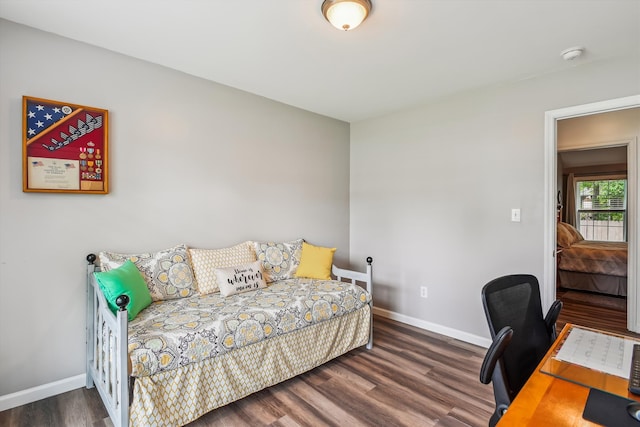 bedroom featuring baseboards and wood finished floors