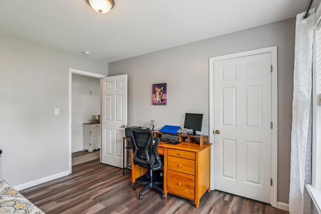office area with baseboards and dark wood-type flooring