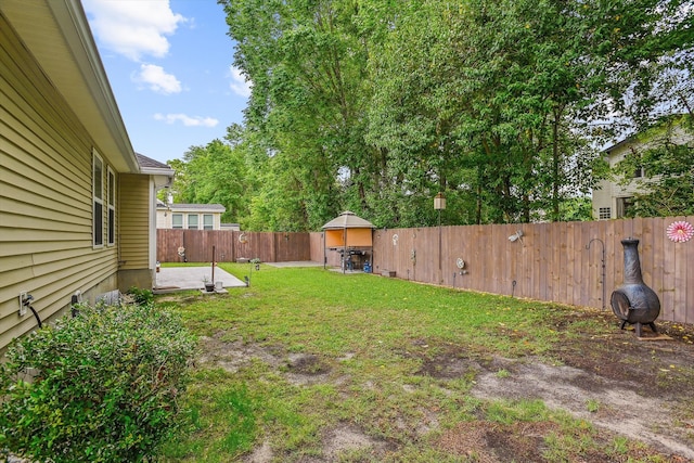view of yard with a patio and a fenced backyard