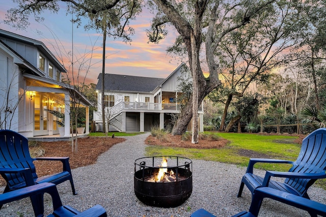 exterior space featuring a yard and an outdoor fire pit