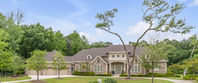 view of front of property with a garage and a front yard