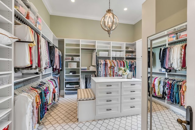 walk in closet featuring light carpet and a chandelier