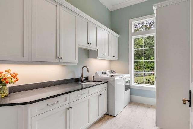 washroom with cabinets, sink, crown molding, and independent washer and dryer