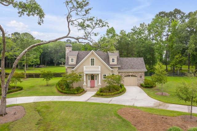 view of front of house featuring a balcony, a front yard, and a garage