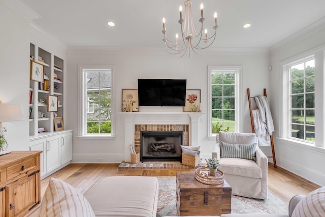 living room featuring a brick fireplace, ornamental molding, light hardwood / wood-style flooring, and built in shelves