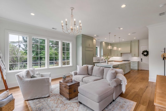 living room with light wood-type flooring, plenty of natural light, and crown molding