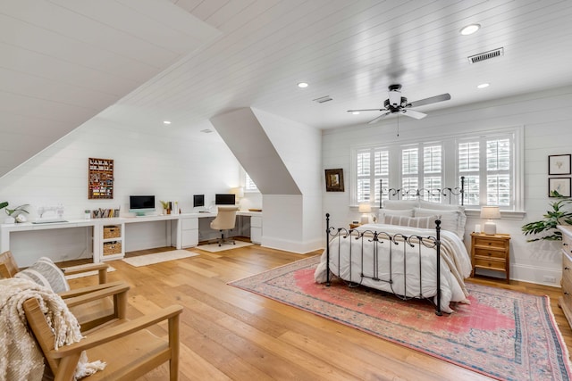 bedroom featuring light hardwood / wood-style floors, ceiling fan, built in desk, and wood ceiling