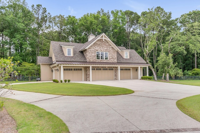 view of front of property with a front lawn and a garage