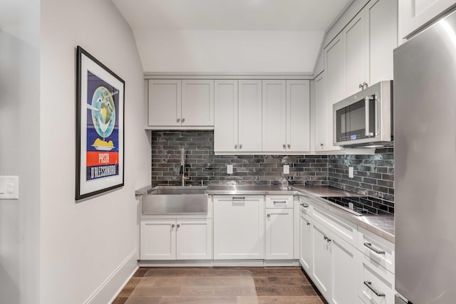 kitchen featuring stainless steel counters, appliances with stainless steel finishes, sink, and white cabinetry