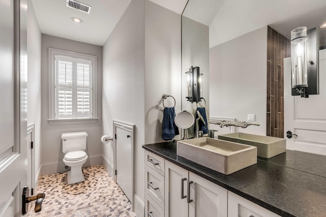 bathroom featuring toilet and vanity