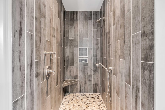 bathroom with a tile shower