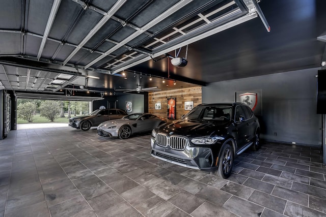 garage with a garage door opener and wood walls