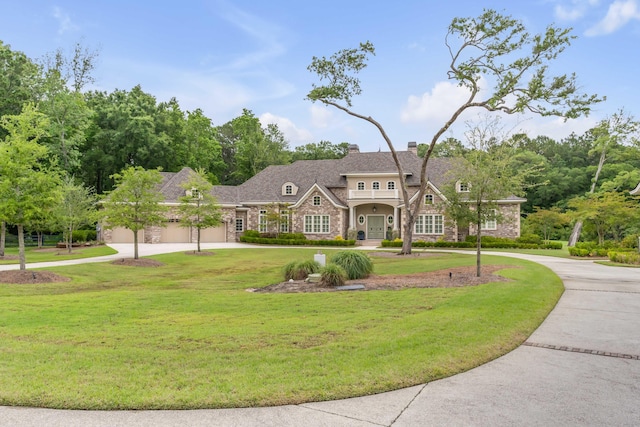 view of front of property featuring a front yard and a garage