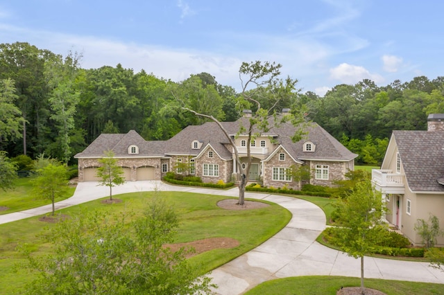 view of front of property with a front lawn and a garage