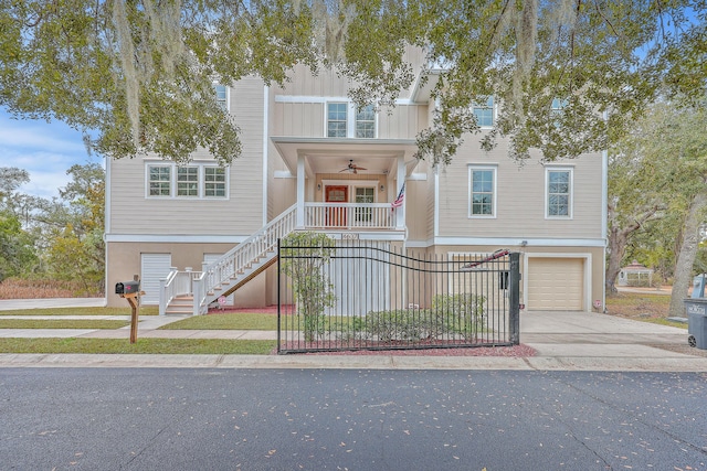 view of front facade with driveway, a garage, a ceiling fan, stairs, and stucco siding