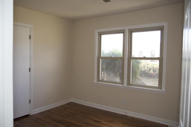 empty room featuring dark hardwood / wood-style flooring