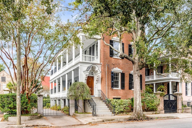 52 Hasell St, Charleston, SC 29401 - townhome / multi-family property featuring a gate, brick siding, a balcony, and fence