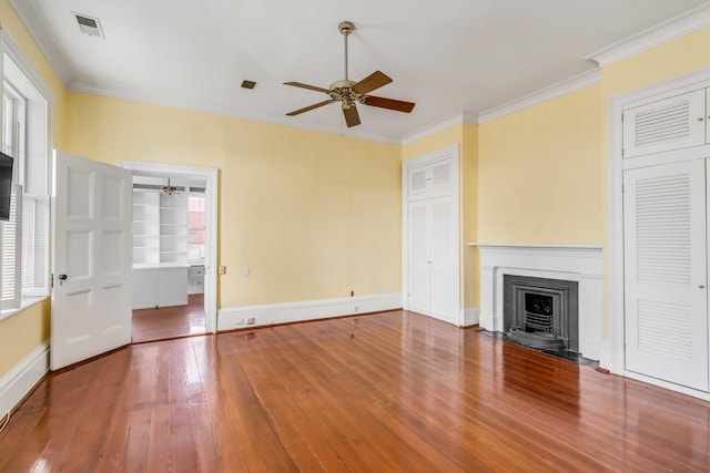 unfurnished living room featuring ceiling fan, wood-type flooring, and ornamental molding