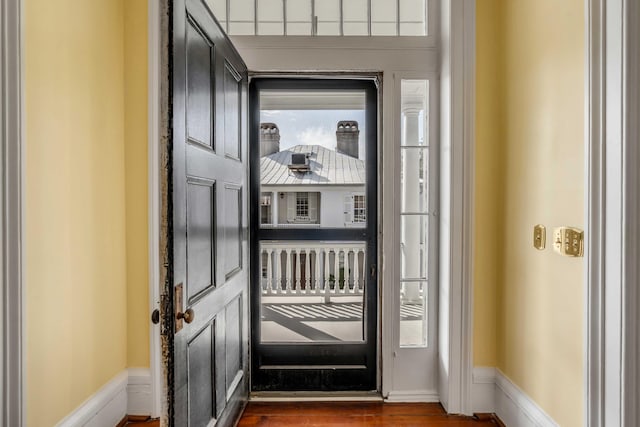 doorway to outside featuring dark wood-type flooring