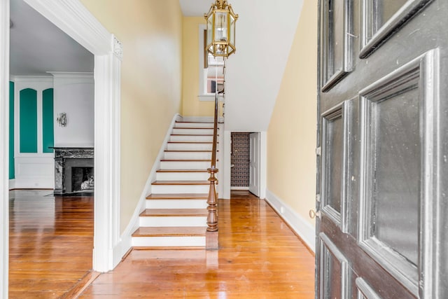 52 Hasell St, Charleston, SC 29401 - foyer with stairway, wood finished floors, a premium fireplace, and baseboards