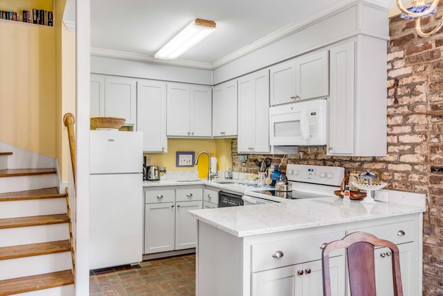 kitchen with white cabinets, kitchen peninsula, sink, light stone countertops, and white appliances