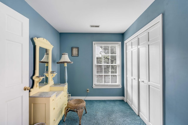 sitting room featuring light carpet