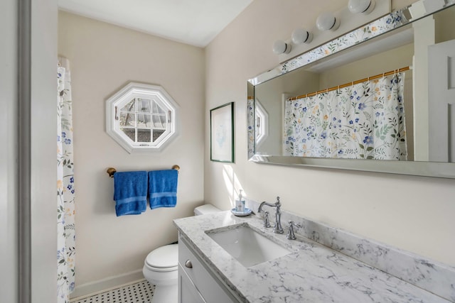 52 Hasell St, Charleston, SC 29401 - bathroom with toilet, vanity, baseboards, and curtained shower