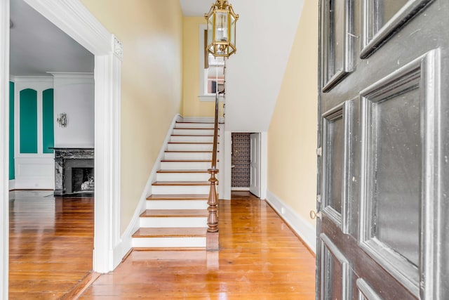 entrance foyer with hardwood / wood-style flooring and crown molding