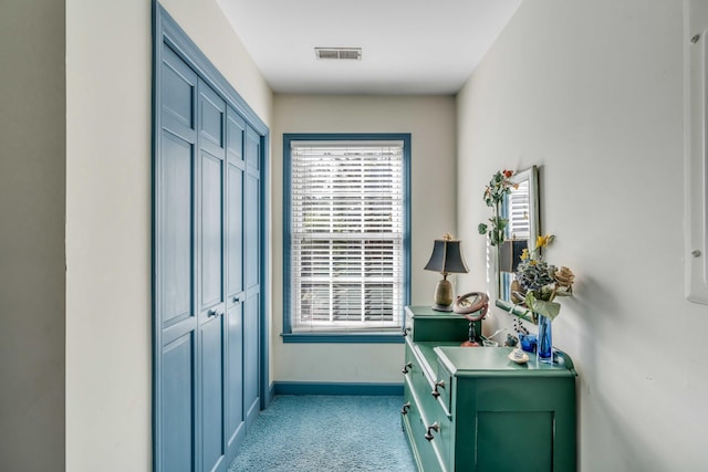 doorway to outside featuring light colored carpet