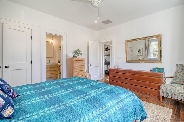 bedroom featuring dark hardwood / wood-style floors, ceiling fan, and ensuite bathroom