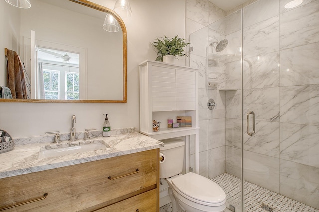 bathroom featuring an enclosed shower, vanity, and toilet