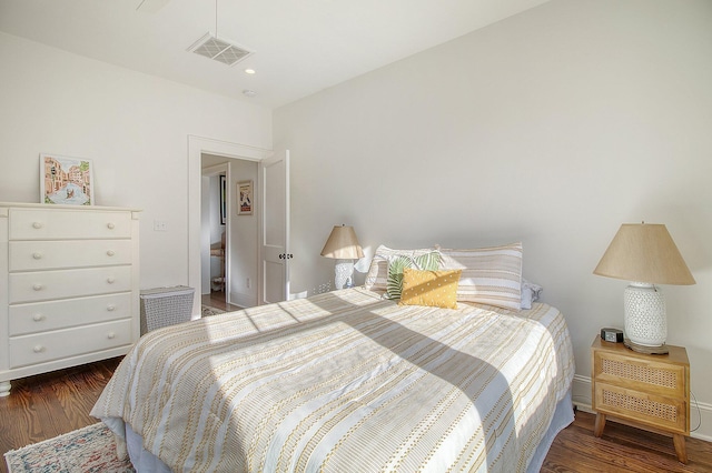 bedroom with dark wood-type flooring