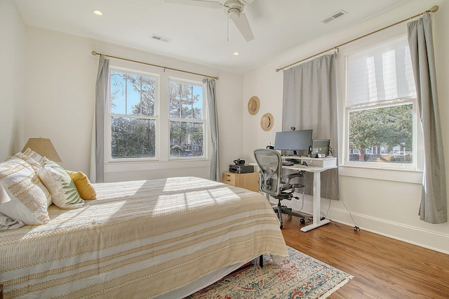 bedroom with wood-type flooring and ceiling fan