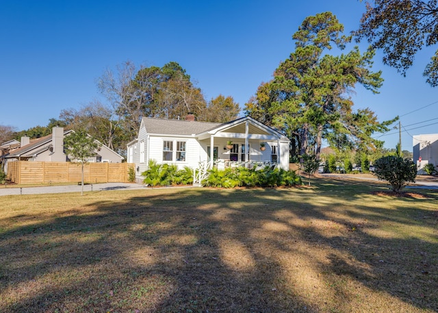 bungalow-style home with a front lawn and a porch