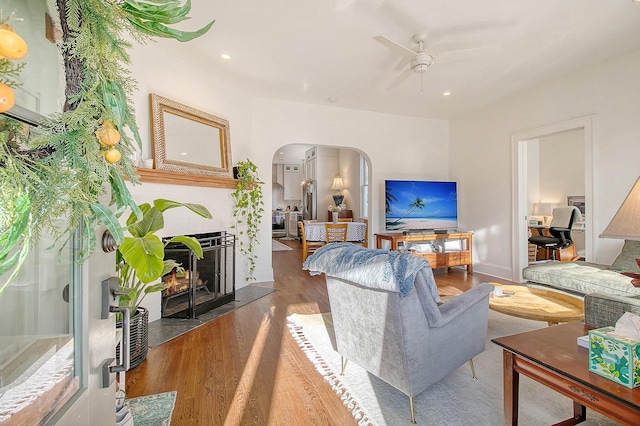 living room featuring wood-type flooring and ceiling fan