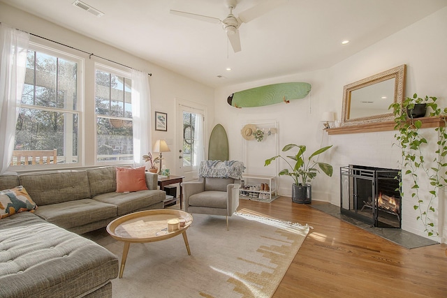 living room with hardwood / wood-style floors and ceiling fan